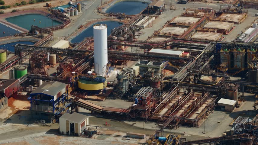 Aerial view of the Mina Cobre Las Cruces industrial mining facility featuring large processing tanks and infrastructure in Gerena, Andalucia, Spain.