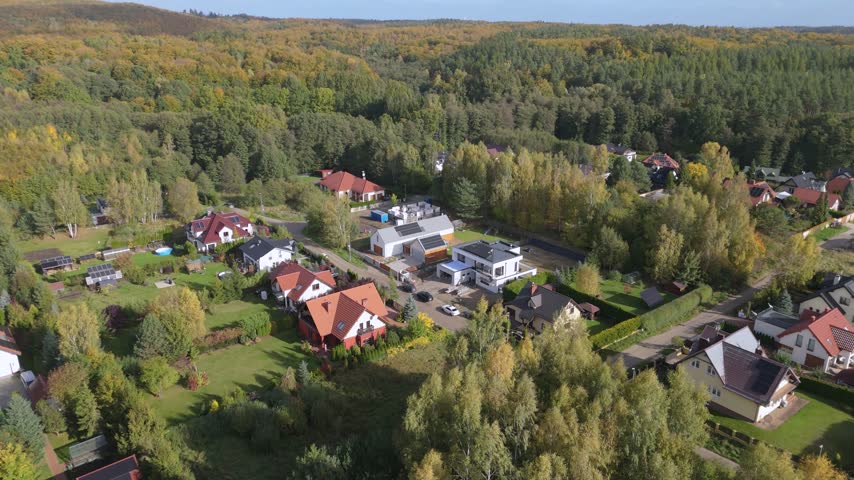 Residential houses surrounded by green trees and forest in a peaceful suburban neighborhood