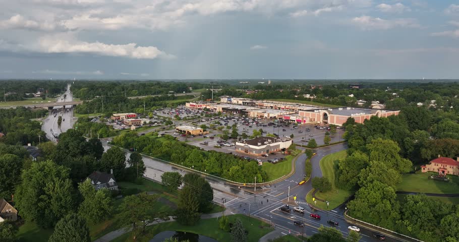 Aerial view of a shopping center with parking lots, surrounding trees, and nearby roads in Crestview Hills, Kentucky, United States.