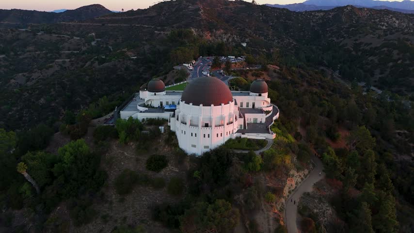 Aerial view of Griffith Observatory situated on Mount Hollywood with surrounding parkland and city views in Los Angeles, California, United States.