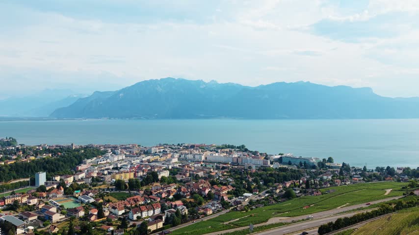 Aerial view of the town of Vevey on the shores of Lake Geneva with the Alps in the background in Vevey, Vaud, Switzerland.