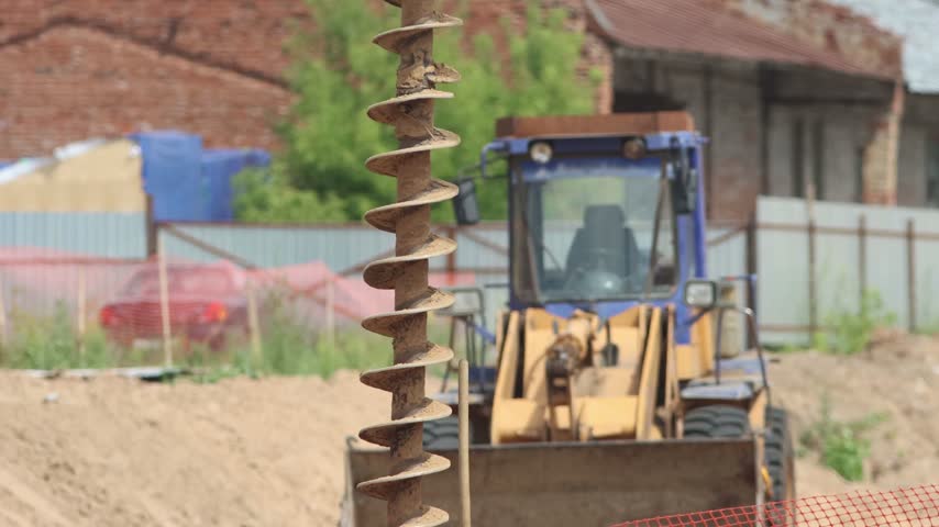 Heavy duty auger drilling a hole at a construction site