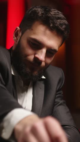 Male gambler making a bet at a casino table surrounded by a luxurious interior. Concept gambling lifestyle and entertainment.
