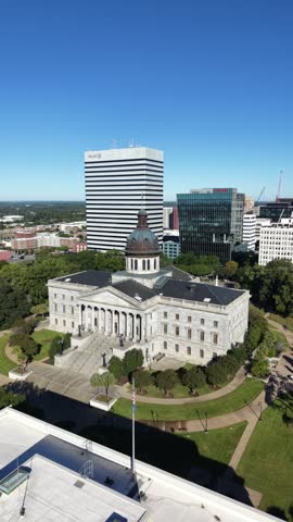 Aerial view of the South Carolina State House with the Columbia skyline behind it