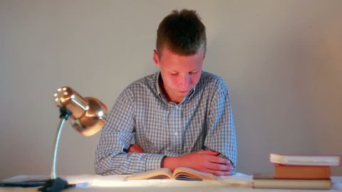 boy studying with books