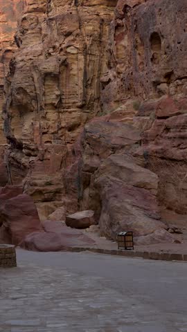 Narrow sandstone passage through the Siq leads toward Petra