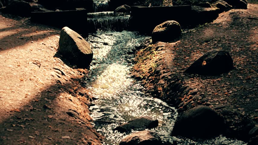 A small waterfall on the river in the autumn Park
