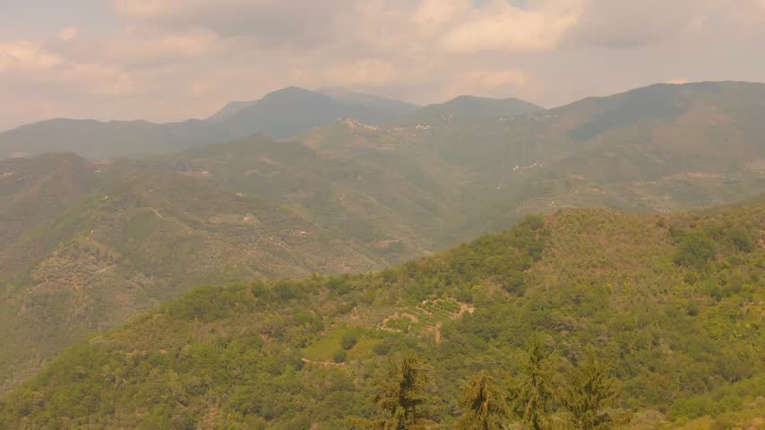 Mountain Slopes And Rugged Hills In The Scenic Landscape Of Liguria In Northwestern Italy. Aerial Shot