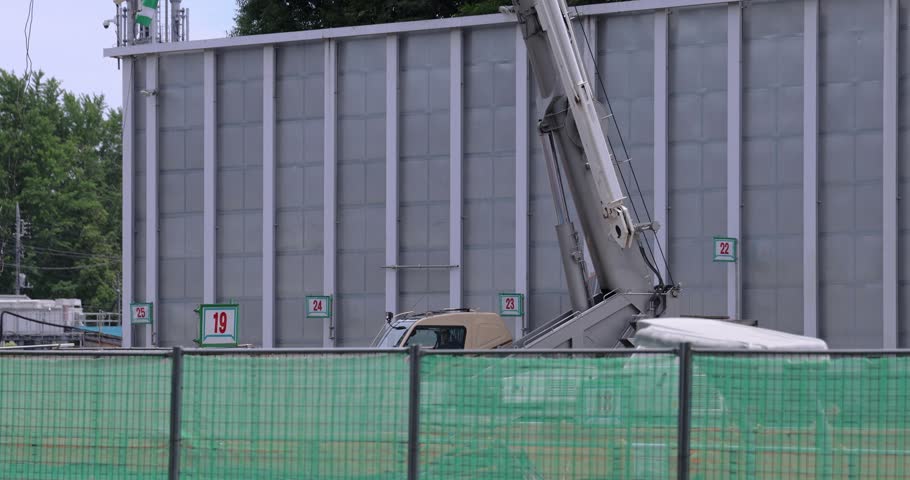 Moving tall cranes at the under construction in the public park cloudy day. High quality 4k footage. Nerima district Tokyo Japan 06.05.2023 Here is a downtown in Tokyo. 