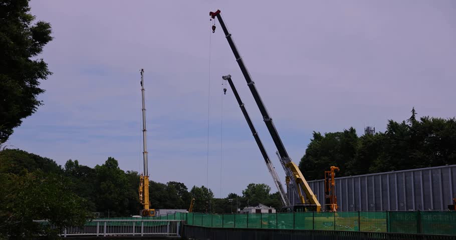 Moving tall cranes at the under construction in the public park cloudy day. High quality 4k footage. Nerima district Tokyo Japan 06.05.2023 Here is a downtown in Tokyo. 
