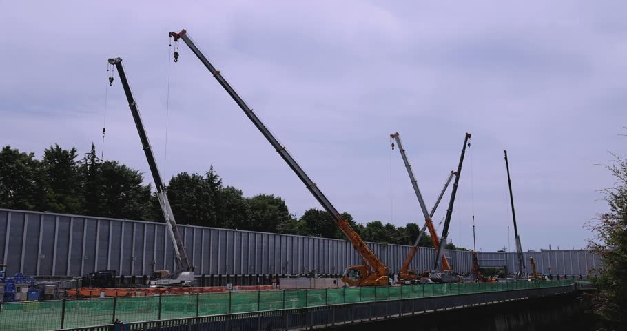 Moving tall cranes at the under construction in the public park cloudy day. High quality 4k footage. Nerima district Tokyo Japan 06.05.2023 Here is a downtown in Tokyo. 