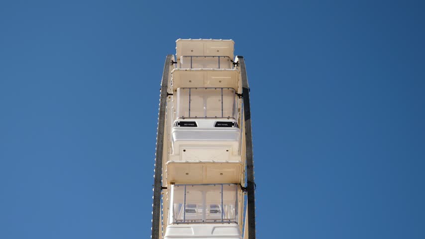 Side View of Giant Wheel with Blue Sky Background