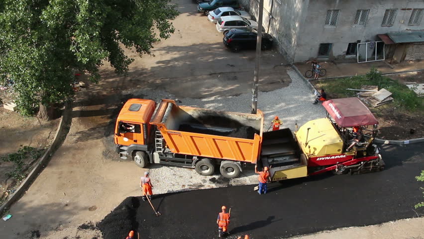UFA, RUSSIA - JUNE 28, 2013: Timelapse - workers laid asphalt with special