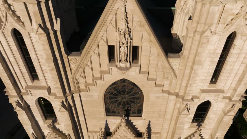Aerial view of the gothic stone facade and spires of Saint Mary Catholic Church in Indianapolis, Indiana, United States.