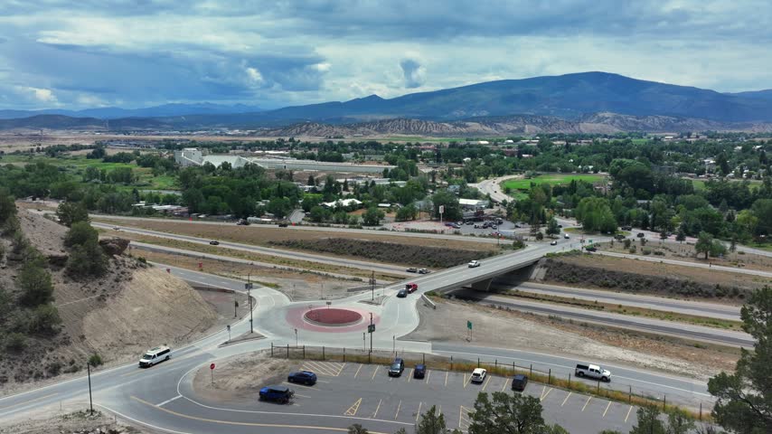 Aerial view of Interstate 70 North Ramp Roundabout with highway traffic and surrounding mountain landscape in Gypsum, Colorado, United States.