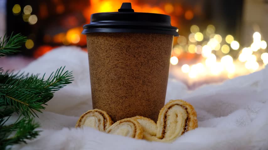Inviting Christmas atmosphere, brown craft paper coffee cups, cute heart‑shaped cookies, a glowing fireplace, and a soft fluffy blanket. Serene atmosphere and quiet comfort, Happy Holidays