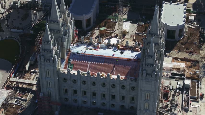 Dolly-out aerial drone close up shot of the famous Salt Lake City Temple under construction, a Latter-day Saints landmark in downtown Salt Lake City, Utah, on a sunny, February day