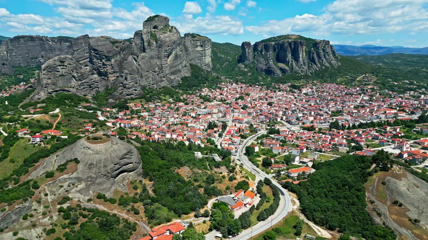 Aerial view of the historic town of Trikala nestled beneath the dramatic rock formations of Meteora, Trikala, Greece.