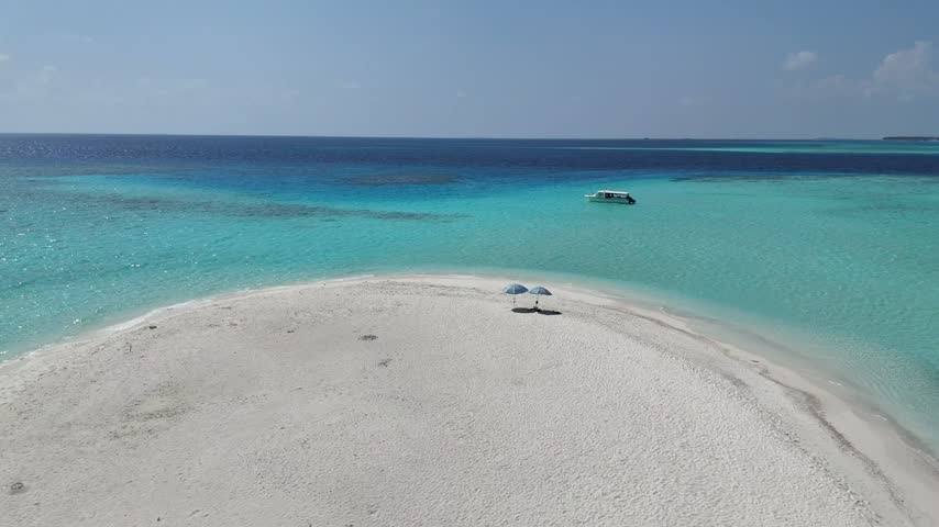 Aerial View of White Sand Beach and Boats in Maldives Lagoon