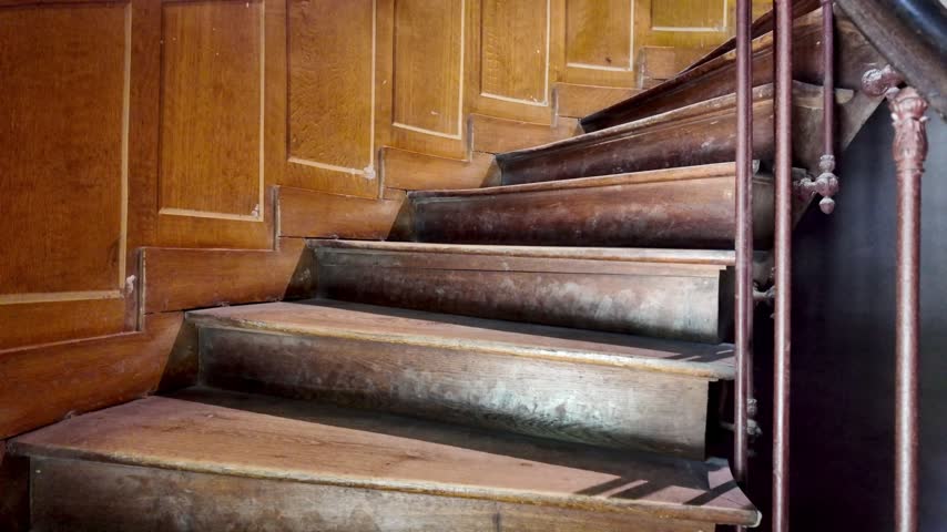 Interior staircase at Azay-le-Rideau Castle in the Loire Valley, showing curved steps and a metal railing.