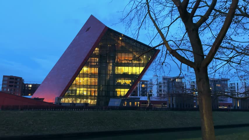 The distinctive architecture of the Museum of the Second World War in Gdansk, Poland, illuminated at twilight. This modern structure houses exhibits detailing WWII history.