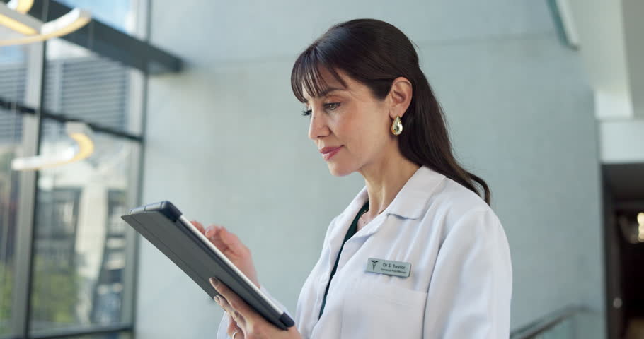 Thinking, hospital and doctor in lobby with tablet, patient report and update for treatment plan. Healthcare, clinic and woman on tech for medical service, telehealth app and solution for medication