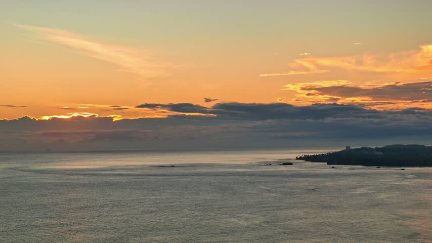 Aerial view of sunset over Madiha Beach with calm ocean waves and golden light in Matara, Southern Province, Sri Lanka.