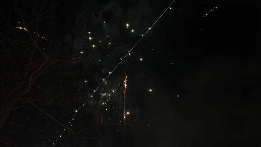 Bright fireworks display bursting in the night sky during new year celebrations