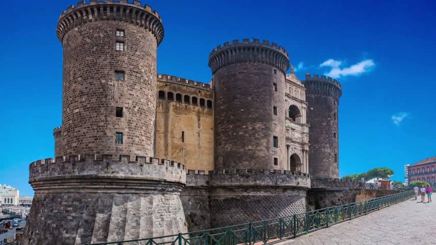 Naples, Italy Majestic view of Castel Nuovo often called Maschio Angioino, a medieval castle located on the seafront. It was a royal seat for the kings of Naples and Aragon.NAPLES ITALY  Castel Nuovo (New Castle) or Maschio Angioino is a medieval castle located in front of Piazza Municipio and the city hall (Palazzo San Giacomo) in central Naples, Napoli, Italy 10.28.2017: Nuovo  often called Maschio Angioino ("Angevin Keep"), is a medieval located in front of Piazza Municipio in centre of Napoli