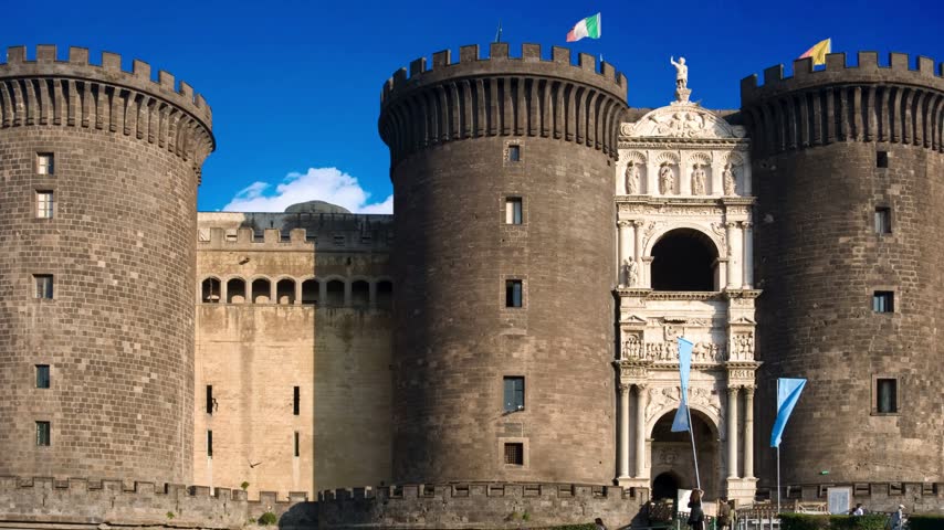 Naples, Italy Majestic view of Castel Nuovo often called Maschio Angioino, a medieval castle located on the seafront. It was a royal seat for the kings of Naples and Aragon.NAPLES ITALY  Castel Nuovo (New Castle) or Maschio Angioino is a medieval castle located in front of Piazza Municipio and the city hall (Palazzo San Giacomo) in central Naples, Napoli, Italy 10.28.2017: Nuovo  often called Maschio Angioino ("Angevin Keep"), is a medieval located in front of Piazza Municipio in centre of Napoli