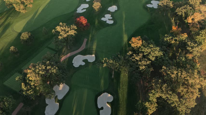 Aerial view of a golf course with sand bunkers and colorful autumn trees in Glenview, Illinois, United States.