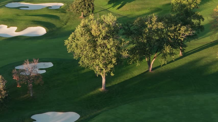 Aerial view of a golf course with sand bunkers and trees in autumn colors in Glenview, Illinois, United States.