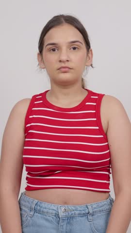 Vertical Shot of Indian Teenage Girl Praying with Folded Hands