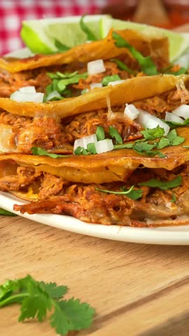 Savory and flavorful quesabirria tacos on a rustic wooden board