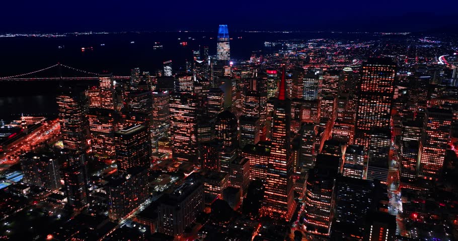 Distancing from the luminous downtown of San Francisco, California, USA. Streets of the city are filled with numerous cars at night.