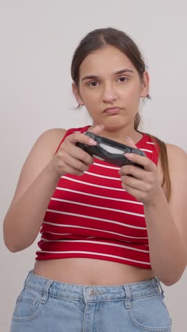 Vertical Shot of Indian Teenage Girl Playing Game with Controller Winning and Celebrating