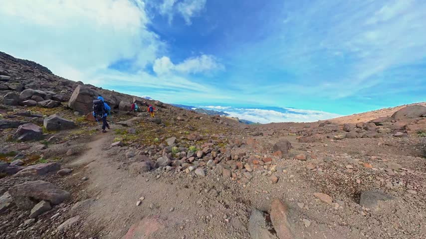 Group of mountaineers hiking a rocky trail on the iztaccihuatl volcano towards otis mcallister shelter