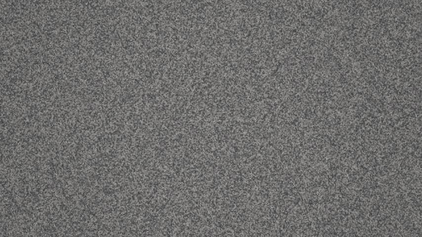 Close up textured background of grey carpet with subtle variations in tone and fiber detail
