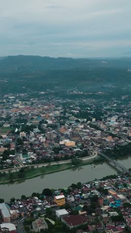 Top view of villages in riverside and highway in Cagayan de Oro. Mindanao, Philippines. Vertical video.