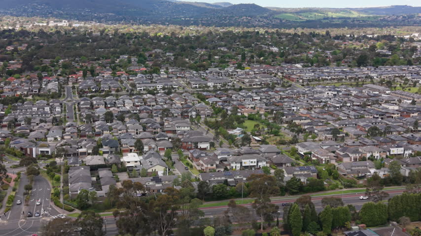 Aerial sideways moving shot of modern houses in a Melbourne suburb, Australia