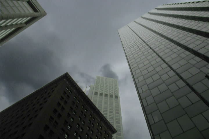 Skyscrapers and storm clouds in composite concept.