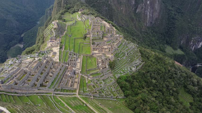 Aerial view over Machu Picchu ruins and green terraces, Peru