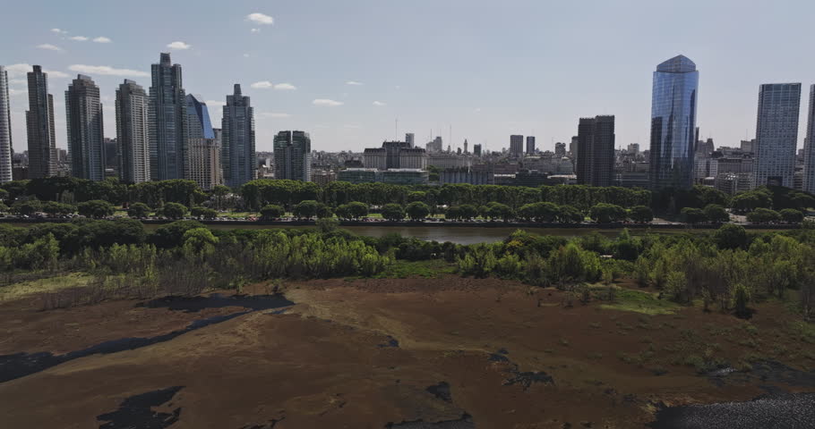 Buenos Aires Argentina Aerial v60 wide high angle tracking flyover across Costanera Sur wetlands toward the Puerto Madero and downtown skyline - Shot with 5k Camera - Jan 3rd 2026