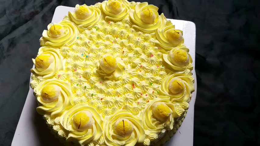 Yellow Frosted Cake with Cream Rosettes