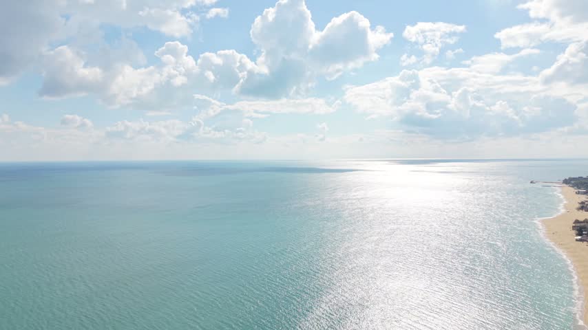 Beautiful Coastal View Showing Clear Blue Water and Curved Sandy Shoreline From Above