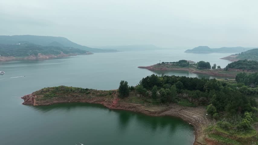 Aerial view of Xiaolangdi reservoir islands and speedboat wake, Yellow River