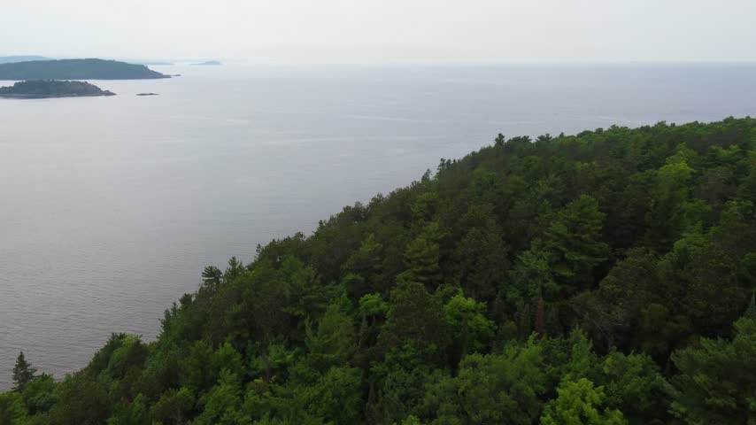 Tree line Aerial just outside Presque Isle Park in Marquette Michigan. Beautiful landscape on the shores of Lake Superior.