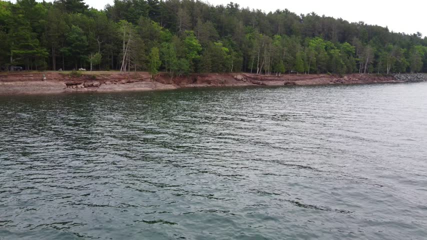 Low approach shore Aerial just outside Presque Isle Park in Marquette Michigan. Beautiful landscape on the shores of Lake Superior.