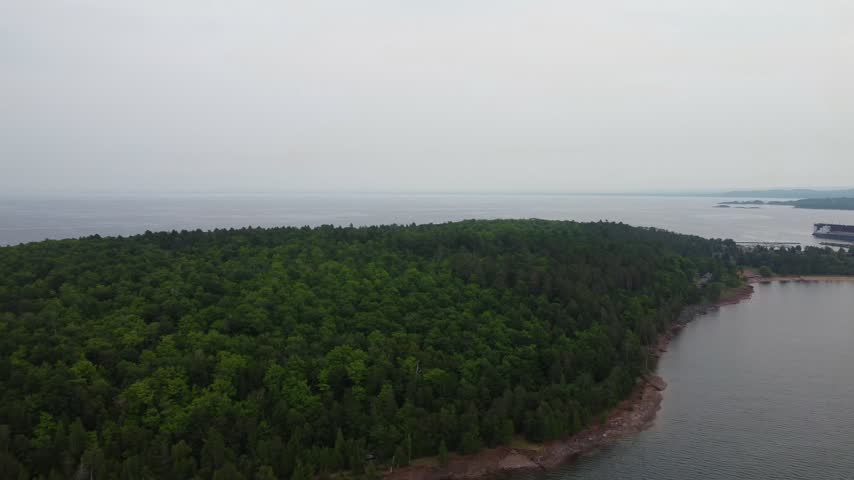 High Aerial just outside Presque Isle Park in Marquette Michigan. Beautiful landscape on the shores of Lake Superior. Iron Ore dock in the distance.