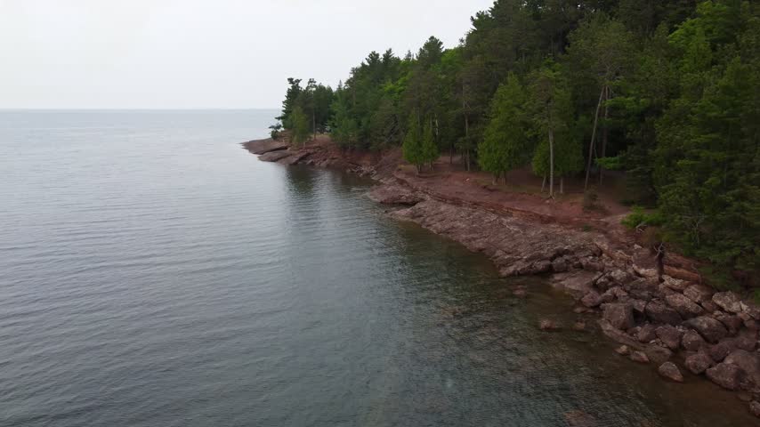 Slow low approach Aerial just outside Presque Isle Park in Marquette Michigan. Beautiful landscape on the shores of Lake Superior.